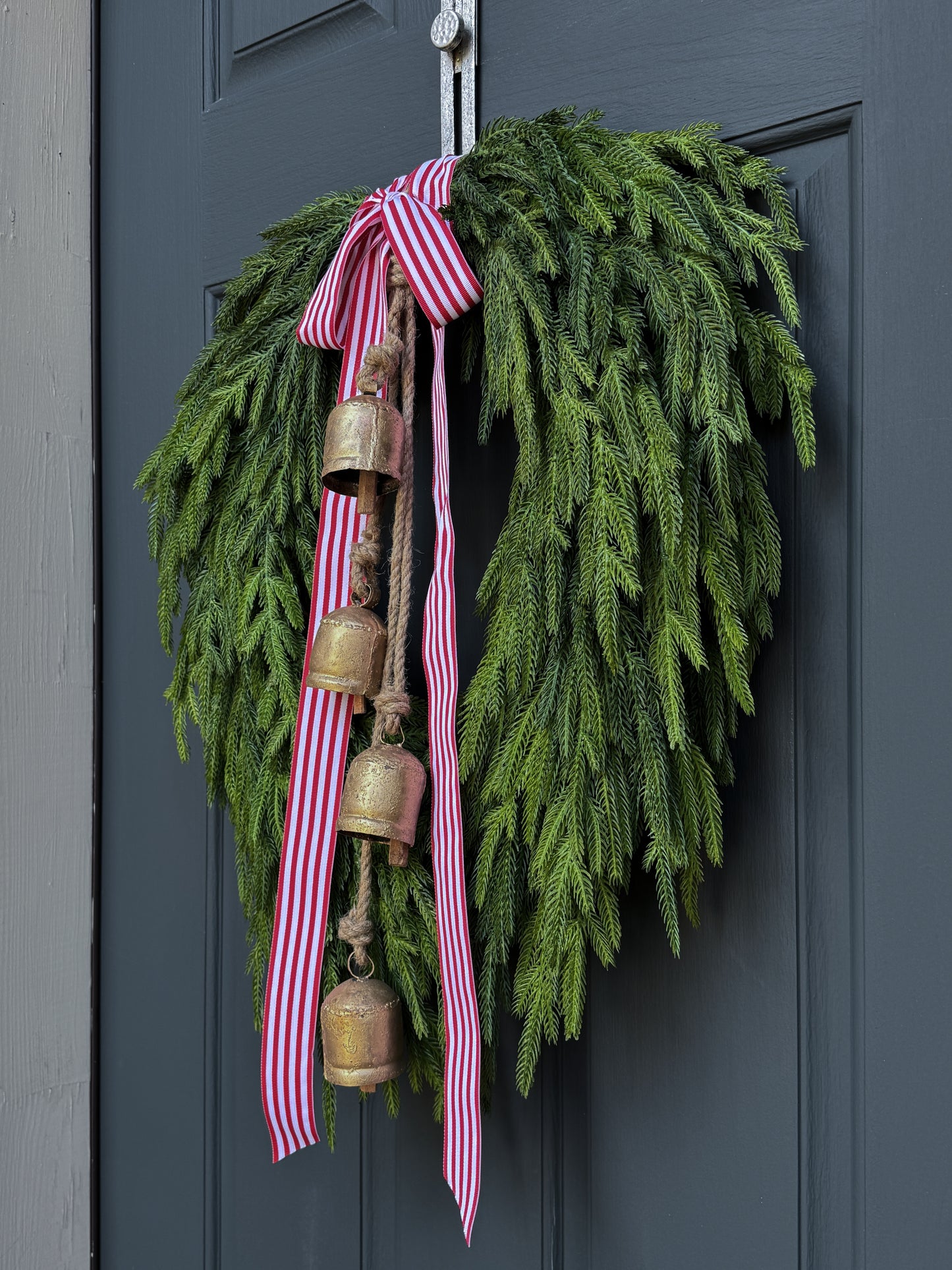 Faux Norfolk Pine Wreath with Bells and Red & White Striped Bow