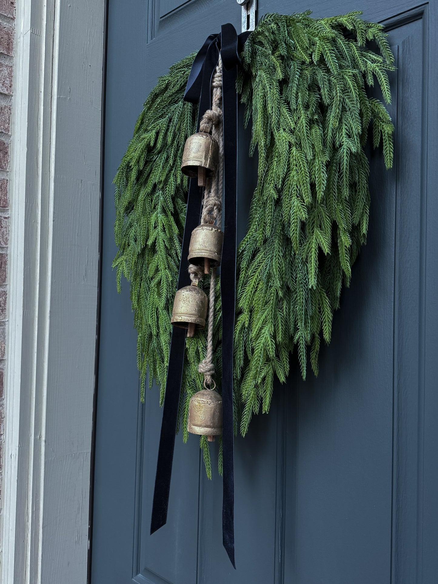 Faux Norfolk Pine Wreath with Bells and Red & White Striped Bow