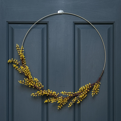 Gold wreath with yellow berries on a blue door