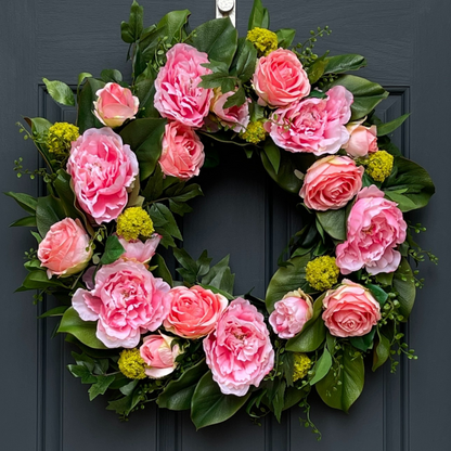 24" Spring Wreath. This high-end, artificial wreath has been handcrafted on a grapevine base and is filled with peonies and roses, and accented with lime green snowball sprays. Florals are nestled in various greenery, including magnolia leaves, shikibu sprays, and button leaf sprays.