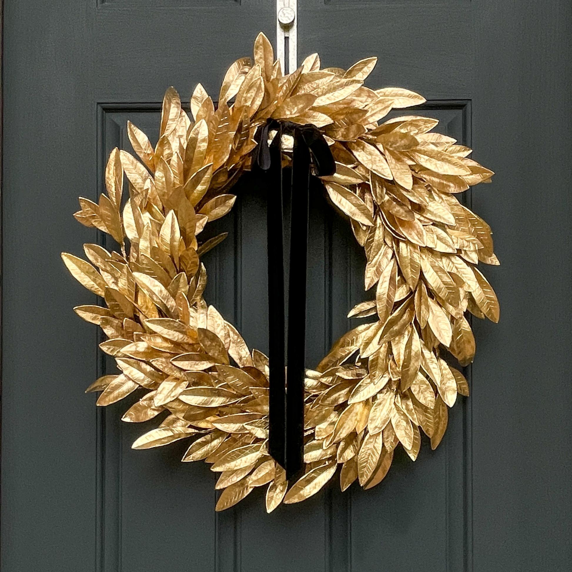 metallic gold bay leaf wreath with black velvet bow