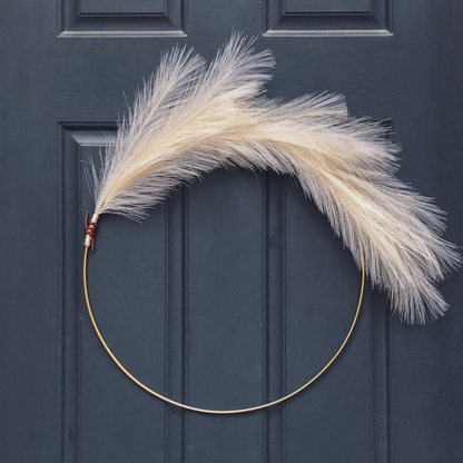 faux pampas hoop wreath with leather wrap detail on dark blue door