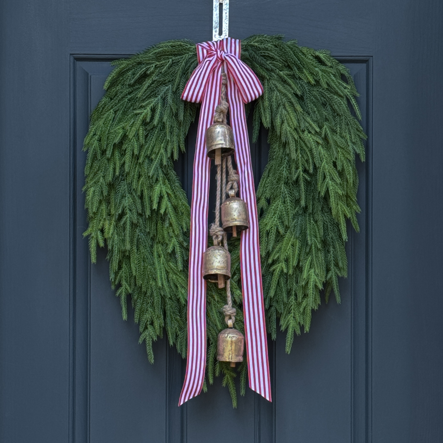 Faux Norfolk Pine Wreath with Bells and Red & White Striped Bow